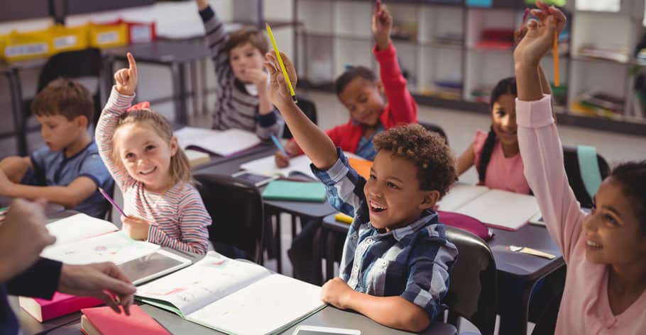 elementary student raising hands